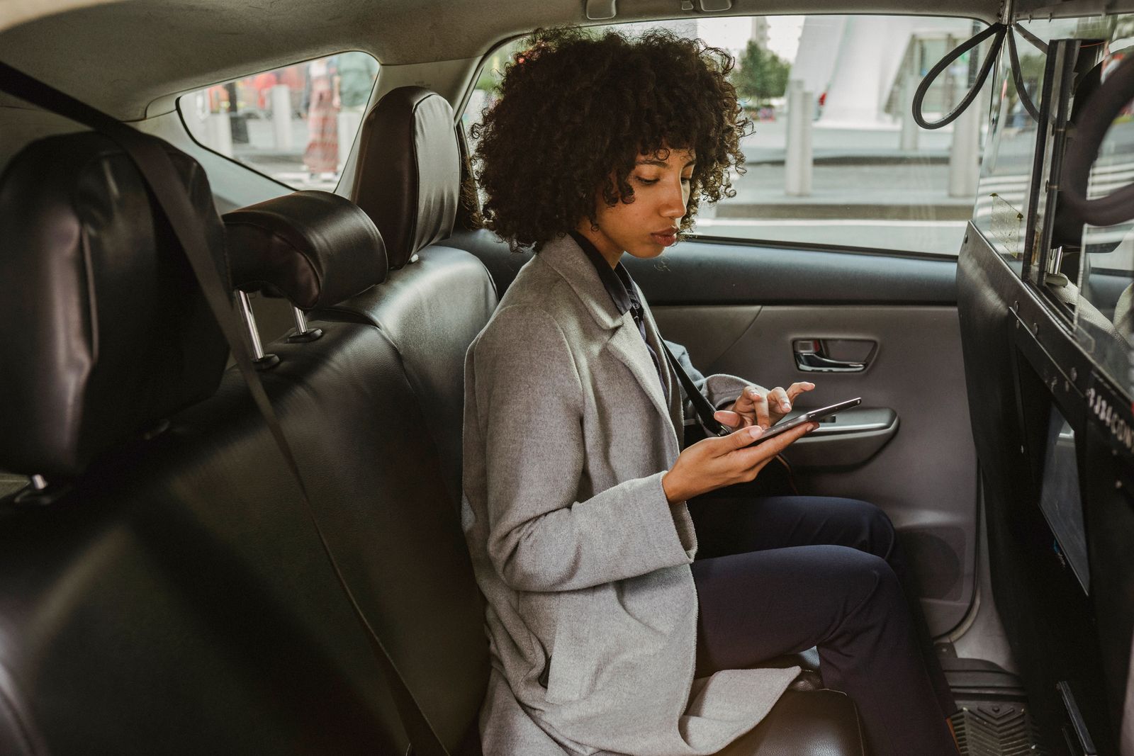 Driver using her phone while seated in a vehicle