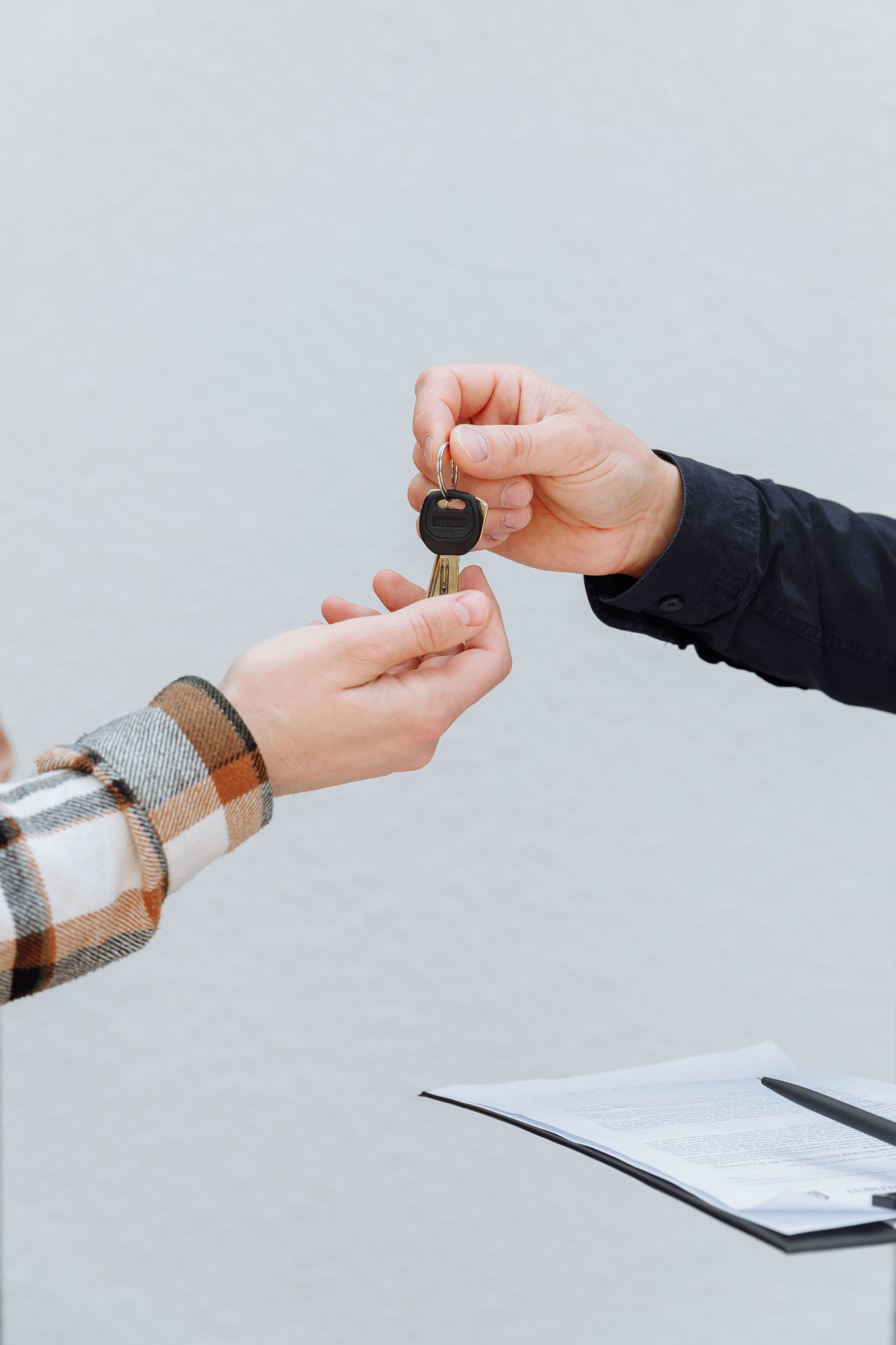 Vehicle keys being handed from one person to another